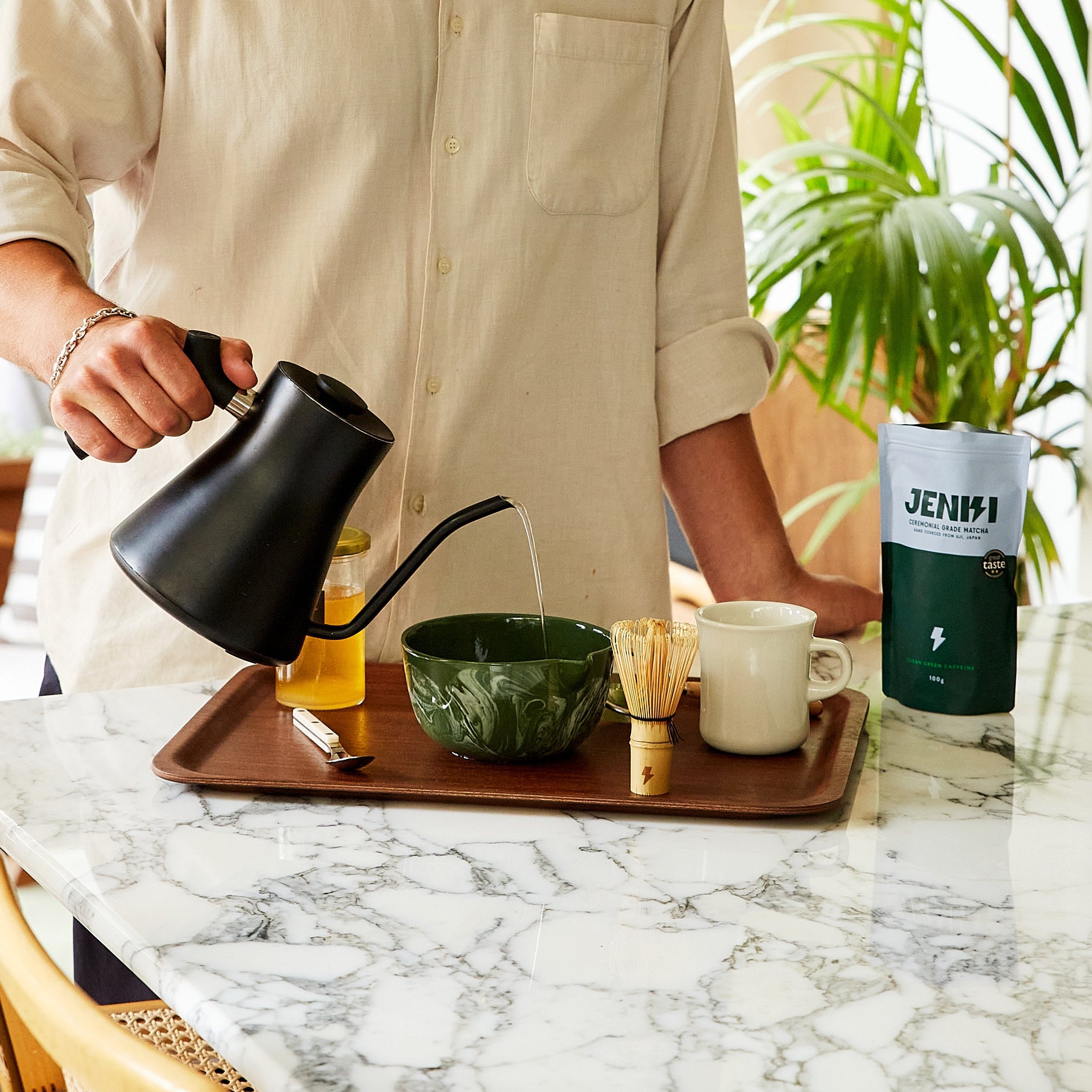 Man pouring coffee into a cup in a kitchen setting